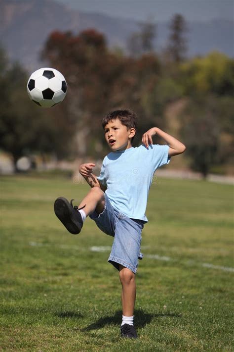 Boy kicking soccer ball stock image. Image of losing - 24075431