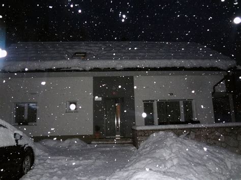 Apartments Fine Stay at night during a snowfall in the holiday season