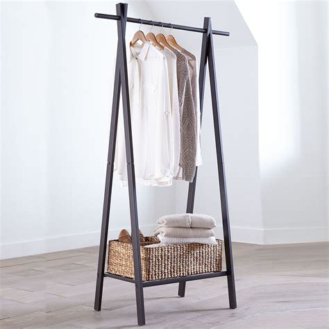 This sleek metal garment rack is perfect for small spaces or rooms with minimal storage. Crafted ...