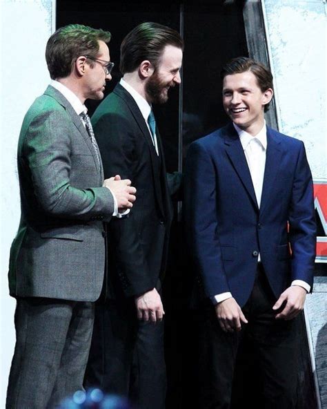 three men in suits are standing next to each other and smiling at the ...