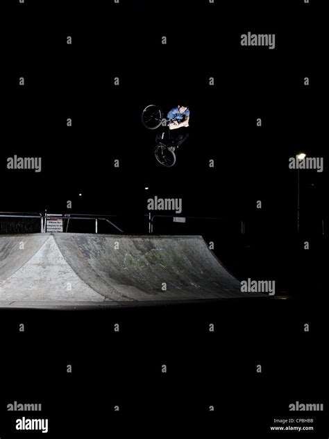 BMX rider performs tricks at an indoor skatepark Stock Photo - Alamy