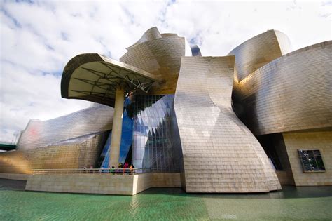 a large building that looks like it is made out of concrete and has many windows