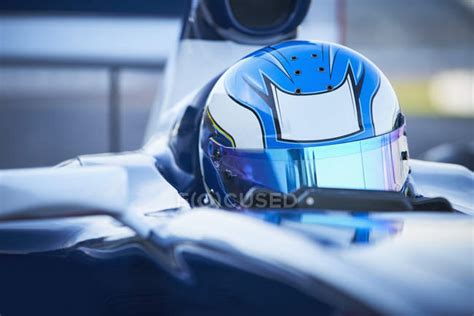 Close up formula one race car driver wearing blue helmet — extreme ...