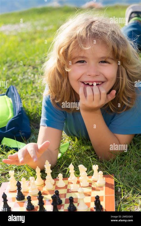 Little kid play chess in park. Child boy playing board game outdoor ...