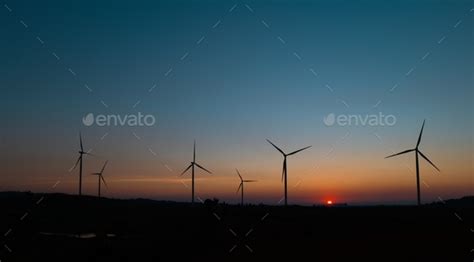 wind turbine field at beautiful sunset sky background. renewable energy ...