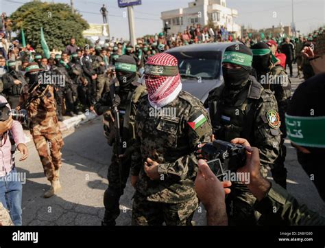 Abu Ubaida, the spokesman of the Izz el-Deen al-Qassam Brigades, walks ...