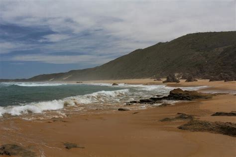 Premium Photo | Sandy beach with big bizarre rocks at brenton on sea