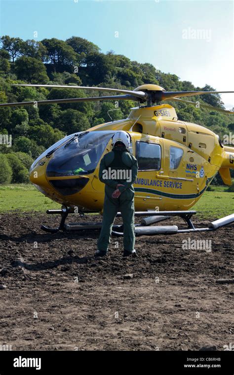 Scottish Ambulance Service air ambulance helicopter preparing and taking off from field after ...