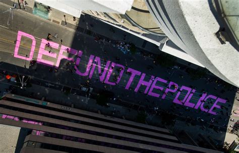 'Defund the police,' painted outside Toronto police headquarters during ...