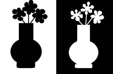 two black and white vases with flowers in them