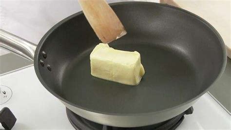 Melting butter in a frying pan - Stock Video Footage - Dissolve