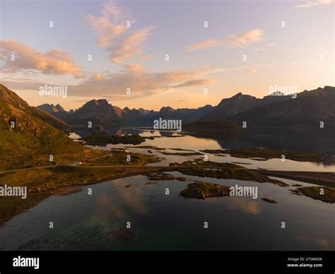 Stunning summer sunset view of Lofoten, Norway scenery from above, with high mountains, fjords ...