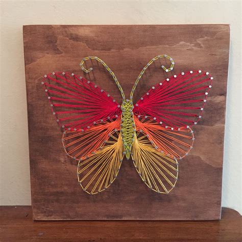 a wooden box with an intricately designed butterfly on it