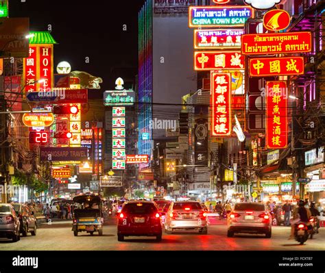 Yaowarat Road in Chinatown, neon signs at night, people and cars, commercial street, billboards ...