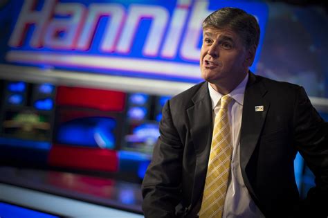 Fox News Channel anchor Sean Hannity poses for photographs as he sits ...