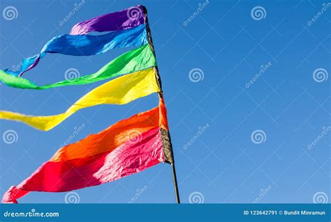 Colorful Rainbow Triangle Flag Shows Up Against the Blue Sky. Stock ...