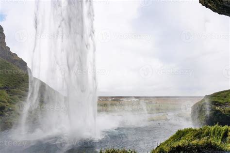 view of Seljalandsfoss waterfall from cave 11691766 Stock Photo at Vecteezy