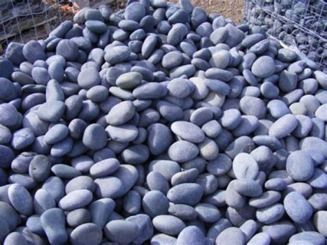 Mexican river rock provides a nice contrast to plant materials ...