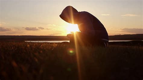 Silhouette of a man praying at sunset concept of religion. Image of silhouette man praying with ...