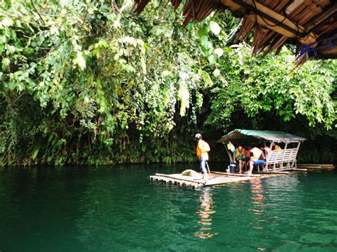 some people are standing on a raft in the middle of a body of water ...