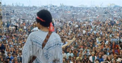 Jimi Hendrix playing to the Woodstock crowd, 1969. : r/OldSchoolCool