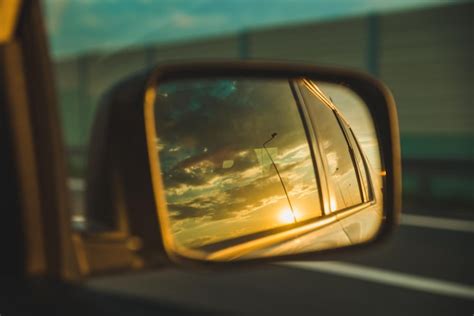 Premium Photo | Car on highway sunset in car mirror reflection