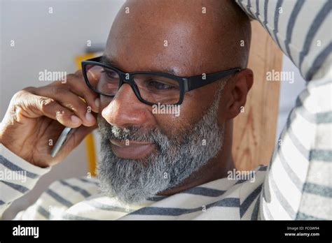 Portrait of bald man grey beard telephoning smartphone Stock Photo - Alamy