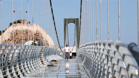 Tourist Pictured Clinging to Glass Bottom Bridge After it Shatters in Heavy Winds