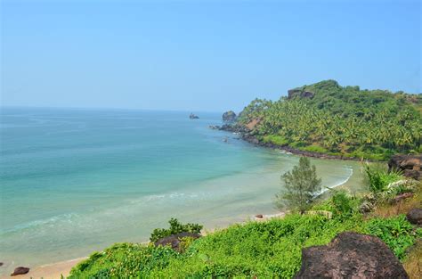 the beach is surrounded by lush vegetation and blue water