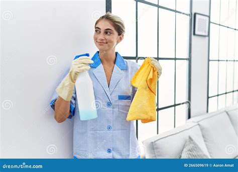 Young Caucasian Woman Wearing Cleaner Uniform Holding Clean Products at ...