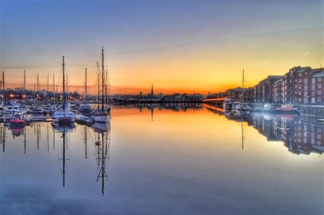 Premium Photo | Boats in harbor at sunset