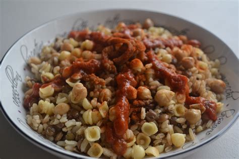 a white bowl filled with pasta and meat