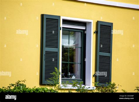 Window with new wooden folding shutter Stock Photo - Alamy