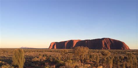 Uluru at sunrise + Kata Tjuta in background, NT, Australia [3264x1624] [OC] : r/EarthPorn