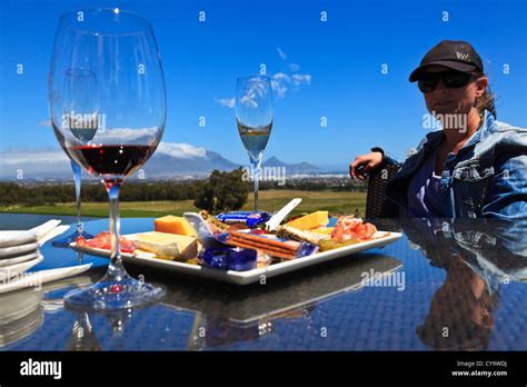 Cape Town, South Africa. A woman tourist at a wine tasting on a Cape ...