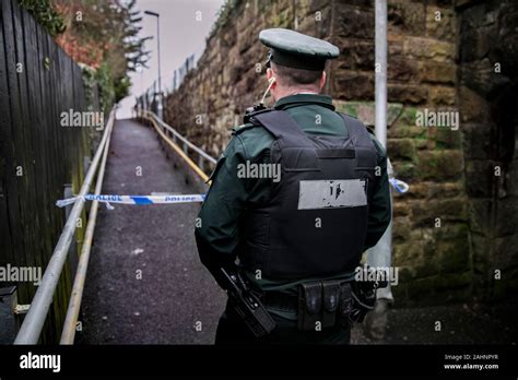 A PSNI officer attending a scene at Dunmurry railway station in west Belfast, Northern Ireland ...