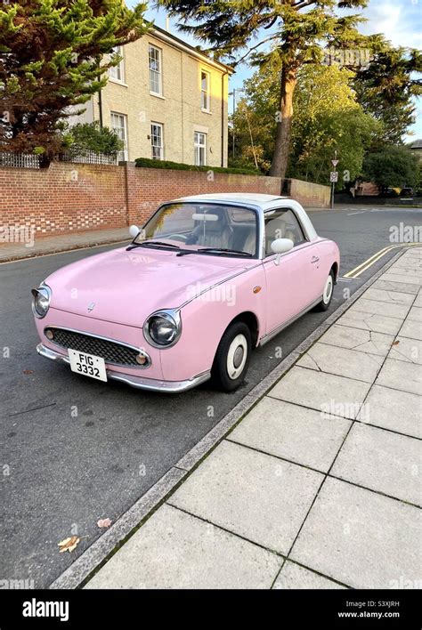 What a beautiful car! A pink Nissan Figaro parked in a residential street Stock Photo - Alamy