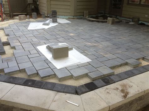 Work in progress patio using Unilock brick pavers. Stonehenge coping ...