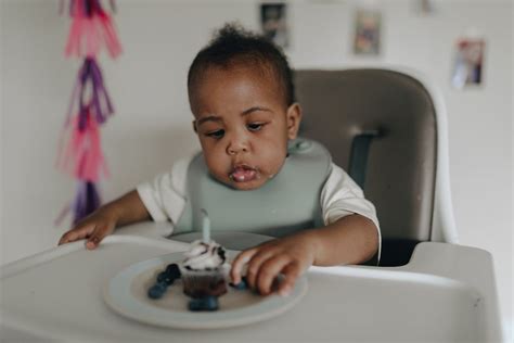 Photograph of a Baby Eating a Cupcake · Free Stock Photo