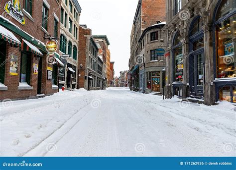 Saint Paul Street in Old Port Montreal on a Winter Day, Road Covered in Snow with No Peopl ...