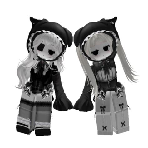 two dolls are dressed in black and white outfits, one is wearing a cat ...