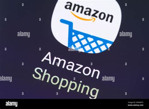 A macro closeup of the Amazon Shopping app logo on a smartphone screen. Amazon focuses on e ...