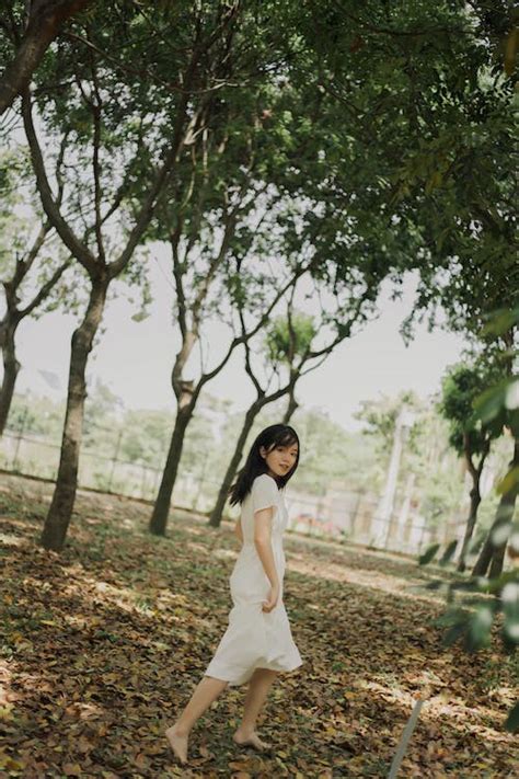 Barefoot Woman Between Trees · Free Stock Photo