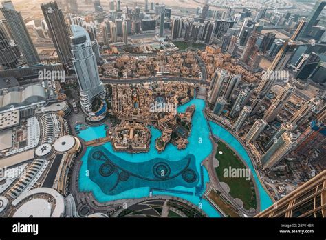 Aerial top view of Dubai famous fountains pool from above in morning from highest tower in world ...