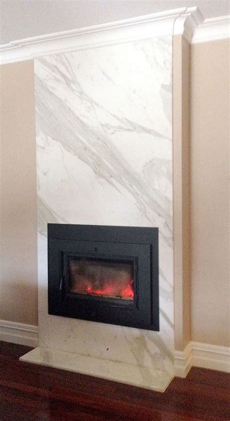 Fireplace clad in Calacatta marble, made by Marable Slab House. #marable | Fireplace tile ...