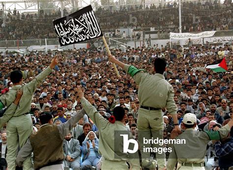 Image of Palestinian Hamas activists wave a Hamas flag during a rally