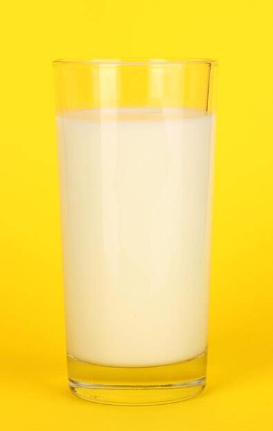 Premium Photo | Glass of fresh new milk on yellow background