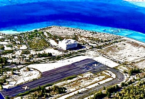 an aerial view of the airport and its surrounding area, with water in the background