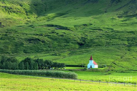 White church in the mountains, Iceland Photograph by Delphimages Photo ...