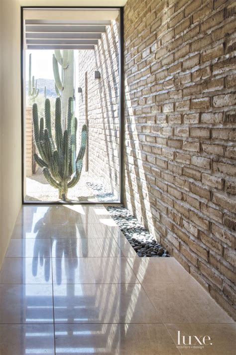 Contemporary Neutral Hallway with River Rock Wall - Luxe Interiors + Design